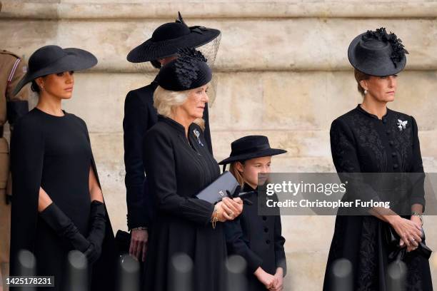 Meghan, Duchess of Sussex, Camilla, Queen Consort, Princess Charlotte of Wales and Sophie, Countess of Wessex watch as The Queen's funeral cortege...