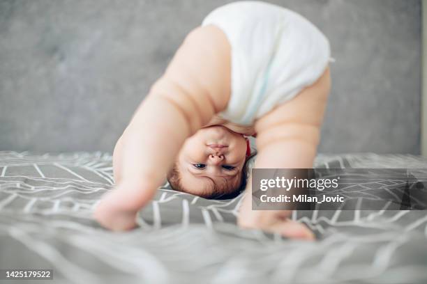 attempting my first steps - cute bums stockfoto's en -beelden