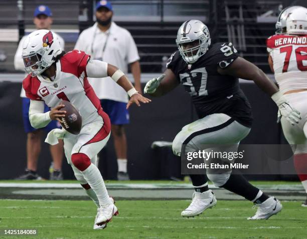 Quarterback Kyler Murray of the Arizona Cardinals gets away from defensive tackle Andrew Billings of the Las Vegas Raiders as Murray scrambles for a...