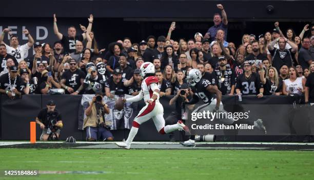 Quarterback Kyler Murray of the Arizona Cardinals scrambles to score a two-point conversion ahead of cornerback Nate Hobbs of the Las Vegas Raiders...