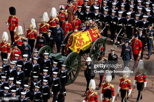 The Queen's funeral cortege borne on the State Gun Carriage of the Royal Navy travels along The Mall and around the Queen Victoria Memorial on...