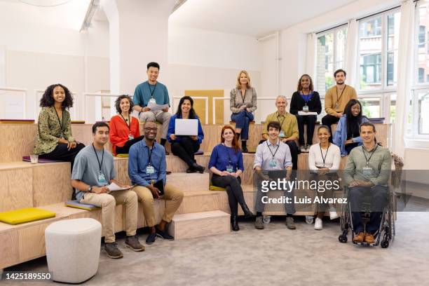 portrait of a multiracial business entrepreneur at startup conference - organised group photo stock pictures, royalty-free photos & images