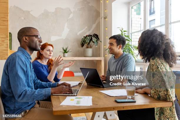 start-up team having a meeting in office - business phone meeting stock pictures, royalty-free photos & images