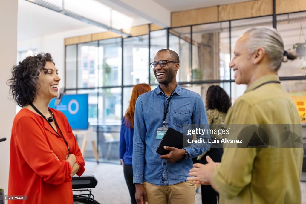 Multiracial business people discussing while meeting at launch event