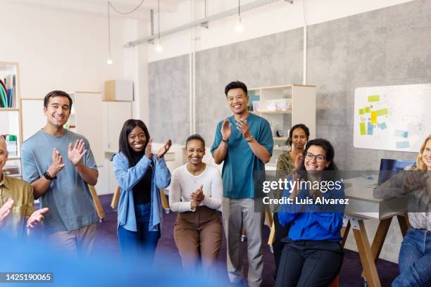 diverse group of people clapping hands after a workshop seminar - launch party inside stock pictures, royalty-free photos & images