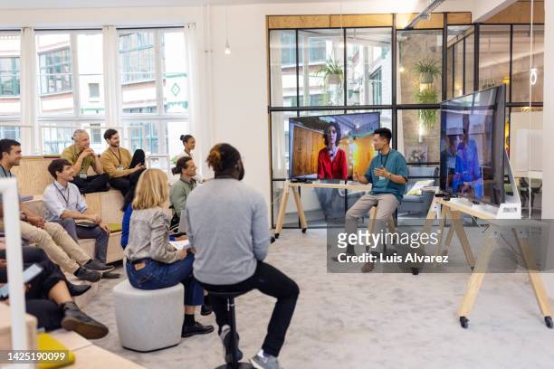 business people having hybrid meeting in office - workshop fotografías e imágenes de stock