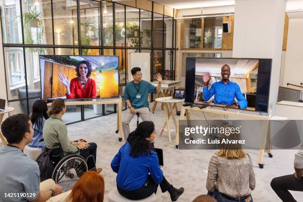 business people having video call with team in office - corporate virtual event stock pictures, royalty-free photos & images