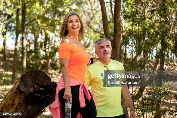 mid age couple in the park - healthy older couple stock pictures, royalty-free photos & images