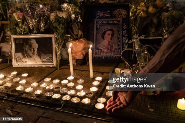 Mourners place candles for Queen Elizabeth II outside the British Consulate as the world reacts to the passing Of Queen Elizabeth II on September 19,...