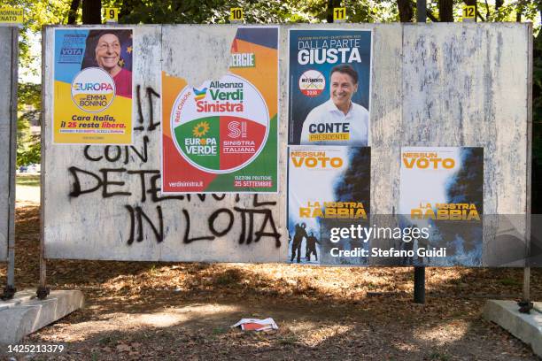 Movimento 5 Stelle di Giuseppe Conte, Emma Bonino and Anarchists Political party election poster stuck on public election grids on September 19, 2022...