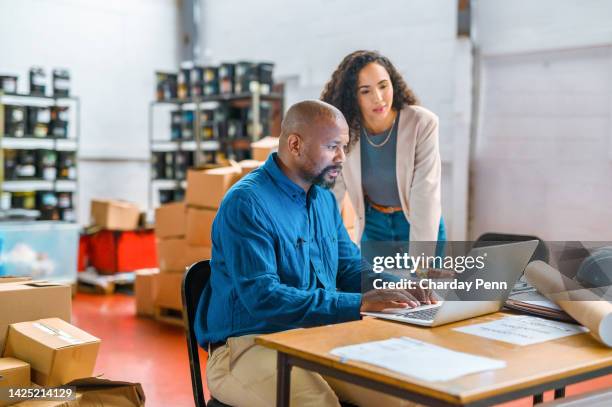 logistics, ecommerce and business people working on laptop delivery, shipping or online shopping orders. cargo, supply chain and checklist with employees in storage, package factory warehouse - factory warehouse workers working together at their desk stock pictures, royalty-free photos & images
