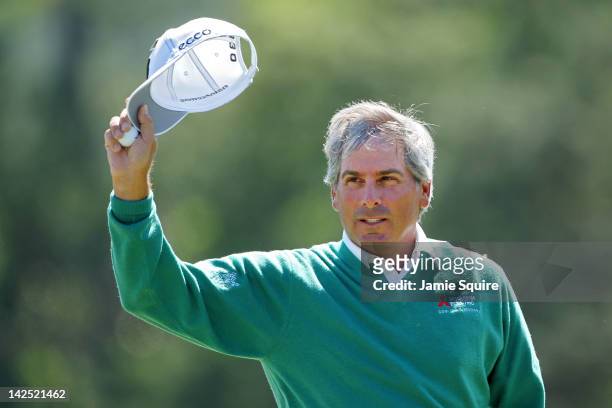 Fred Couples of the United States gestures to the gallery from the 18th green after finishing the second round of the 2012 Masters Tournament at...