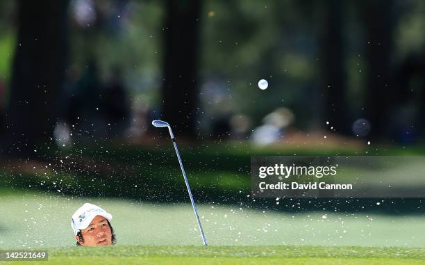 Ryo Ishikawa of Japan hits a shot out of the bunker on the 17th hole during the second round of the 2012 Masters Tournament at Augusta National Golf...