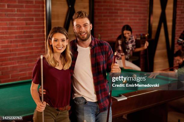 lovely couple having a date night and playing pool in the pool hall - pool table stock pictures, royalty-free photos & images