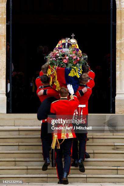 Pall bearers carry the coffin of Queen Elizabeth II with the Imperial State Crown resting on top into St. George's Chapel on September 19, 2022 in...
