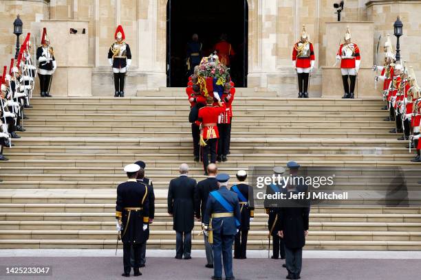 Pall bearers carry the coffin of Queen Elizabeth II with the Imperial State Crown resting on top into St. George's Chapel on September 19, 2022 in...