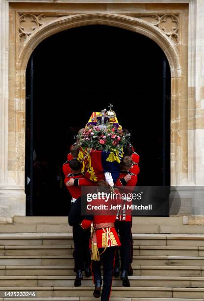 Pall bearers carry the coffin of Queen Elizabeth II with the Imperial State Crown resting on top into St. George's Chapel on September 19, 2022 in...