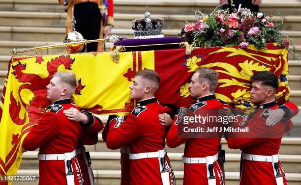 Pall bearers carry the coffin of Queen Elizabeth II with the Imperial State Crown resting on top to St. George's Chapel on September 19, 2022 in...