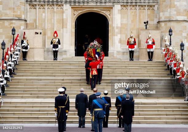 Pall bearers carry the coffin of Queen Elizabeth II with the Imperial State Crown resting on top into St. George's Chapel on September 19, 2022 in...