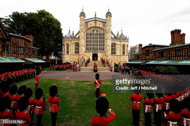 General view of pall bearers from the first battalion Grenadier Guards as they carry the coffin of Queen Elizabeth II with the Imperial State Crown...