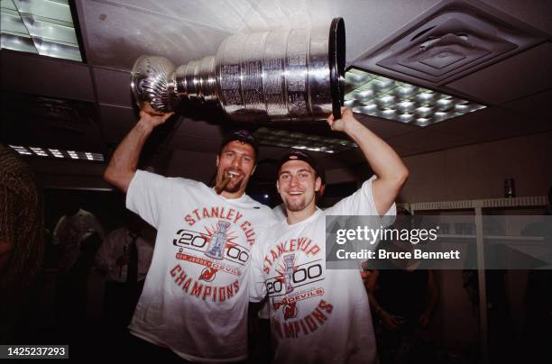 Scott Stevens and Brian Rafalski of the New Jersey Devils celebrates the Stanley Cup victory in June 2000 in East Rutherford, New Jersey.
