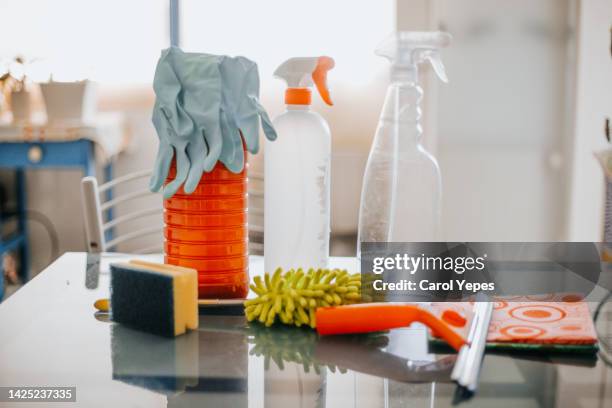 collection of cleaning supplies on surface of the kitchen table - upper_house stock-fotos und bilder