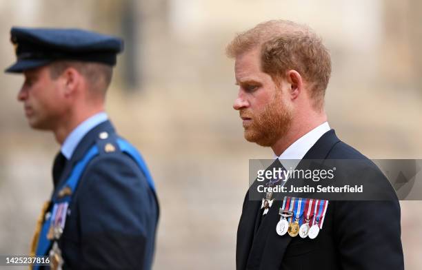 Prince William, Prince of Wales and Prince Harry, Duke of Sussex join the Procession following the State Hearse carrying the coffin of Queen...