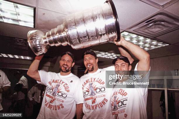 Ken Daneyko, Scott Stevens and Brian Rafalski of the New Jersey Devils celebrate the Stanley Cup victory in June 2000 in East Rutherford, New Jersey.