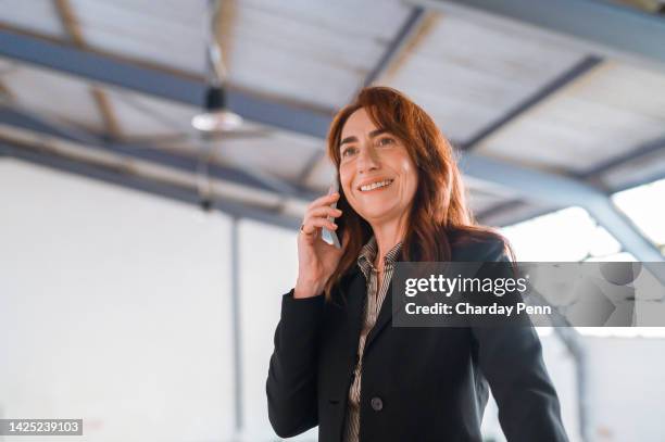 real estate, phone networking and real estate agent property manager in warehouse, commercial studio or office space building development. smile, happy and mature woman or insurance worker with mortgage deal - old factory stock pictures, royalty-free photos & images