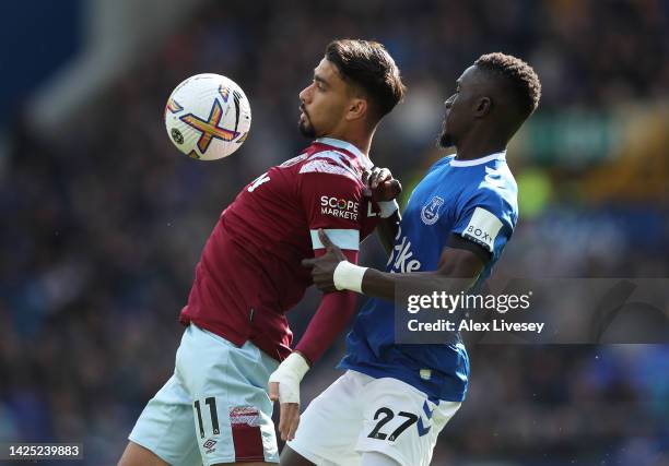 Lucas Paqueta of West Ham United holds off Idrissa Gueye of Everton FC during the Premier League match between Everton FC and West Ham United at...