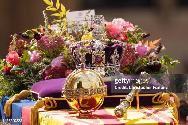The coffin of Queen Elizabeth II with the Imperial State Crown resting on top is carried by the Bearer Party as it departs Westminster Abbey during...