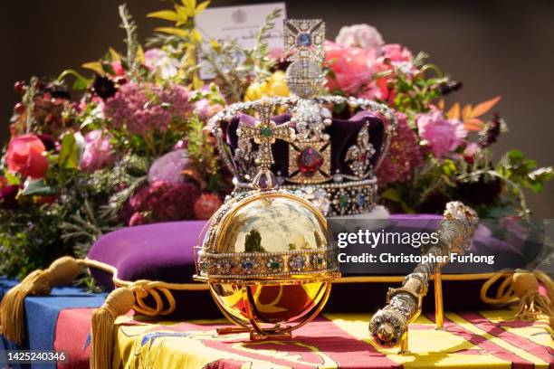 The coffin of Queen Elizabeth II with the Imperial State Crown resting on top is carried by the Bearer Party as it departs Westminster Abbey during...