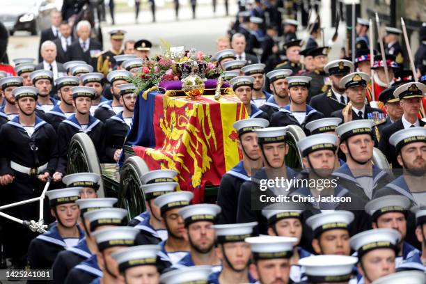 Members of the Royal Navy lead HM Queen Elizabeth's coffin to Westminster Abbey during The State Funeral Of Queen Elizabeth II at Westminster Abbey...