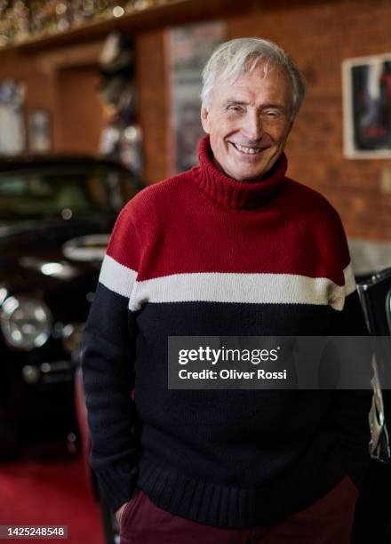 portrait of smiling senior man with classic vintage cars in garage - old car interior stock pictures, royalty-free photos & images