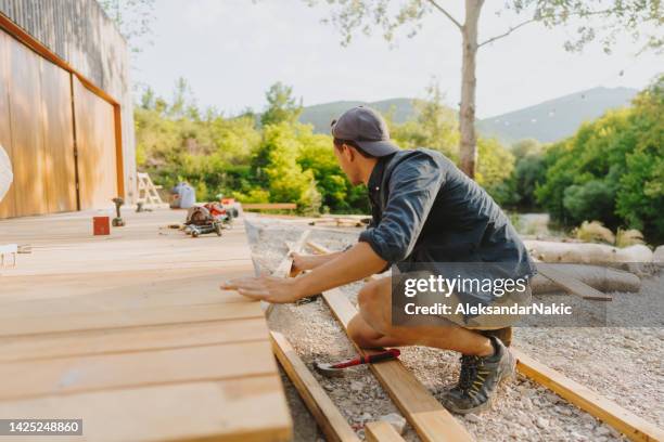 zimmermann, die arbeit an seinem projekt - terrasse grundstück stock-fotos und bilder