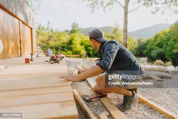 carpenter working on his project - deck stock pictures, royalty-free photos & images