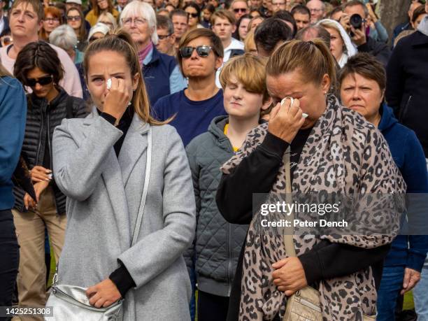 Mourners gather in Hyde Park to watch giant screens showing the state funeral of Queen Elizabeth II on September 19, 2022 in London, England....