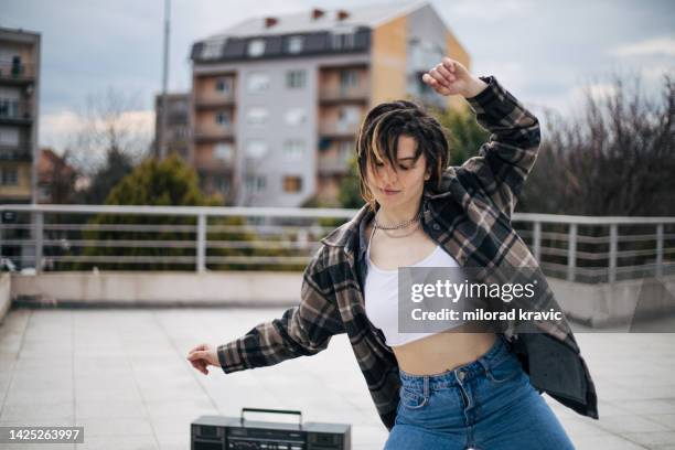 young girl is dancing on the rooftop - cropped tops stock pictures, royalty-free photos & images