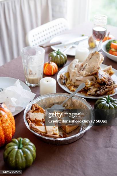 high angle view of thanksgiving table after feast,leftovers and dirty dishes - thanksgiving leftovers stock pictures, royalty-free photos & images