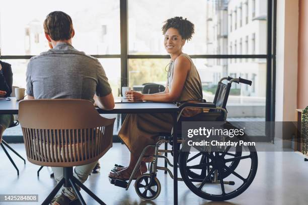 business woman with disability in wheelchair in meeting at work, happy with corporate diversity at company and partnership with team at marketing agency. portrait of employee in inclusive office - social inclusion stock pictures, royalty-free photos & images