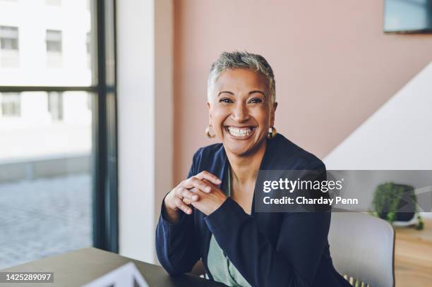 senior, happy and smile of a proud corporate woman ceo of a company at her office desk. portrait of a business leader, manager and boss feeling worker, career and management success at a company - the evolution of the female gaze stock pictures, royalty-free photos & images