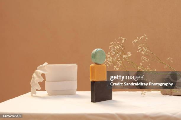 bars of soap on a yellow and white background, with marine and floral decoration, with a white paper packaging bag - flexible packaging stock pictures, royalty-free photos & images