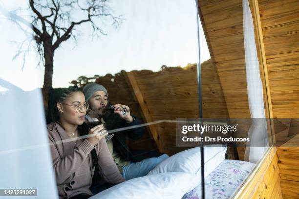 couple enjoying vacation in a chalet - holiday house stock pictures, royalty-free photos & images