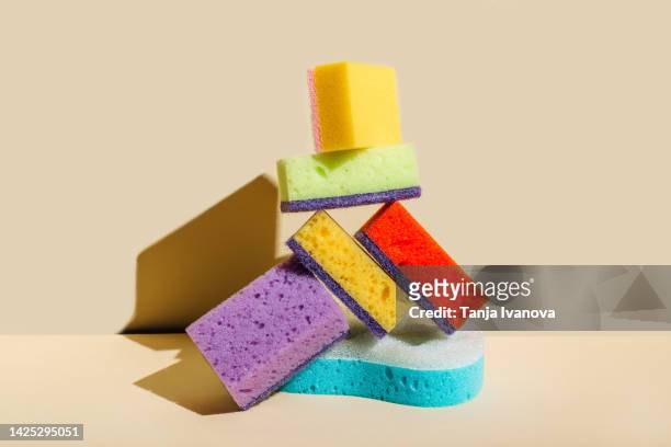 colored sponges for washing dishes and cleaning on beige background. the concept of cleanliness in the house - washing dishes bildbanksfoton och bilder