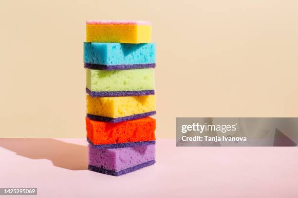 colored sponges for washing dishes and cleaning on beige background. the concept of cleanliness in the house - sponge fotografías e imágenes de stock