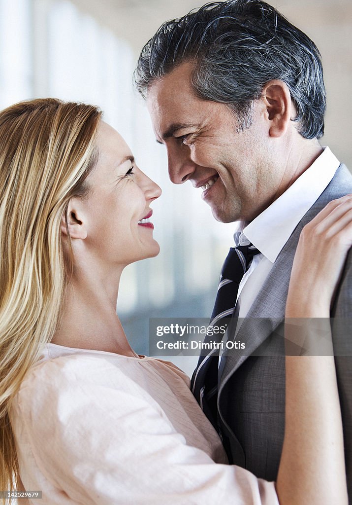 Romantic couple embracing, smiling, close-up
