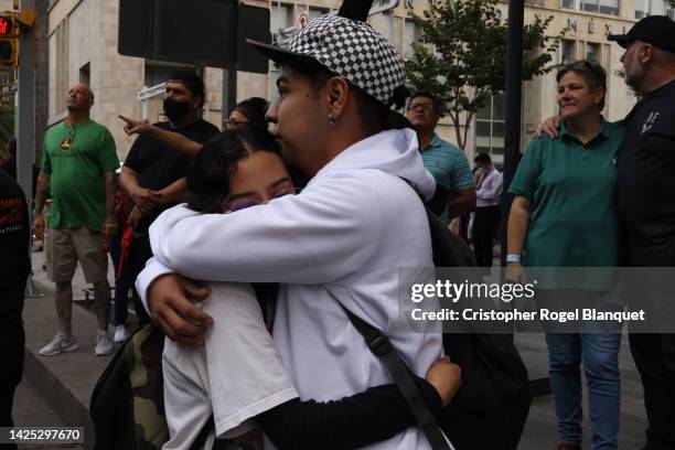 Couple hug in the street after a 7.7 magnitude quake that struck the west coast in Michoacan State, was felt in Mexico City right after a drill to...