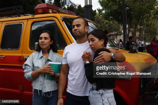People gather outside after a 7.7 magnitude quake that struck the west coast in Michoacan State, was felt in Mexico City right after a drill to...
