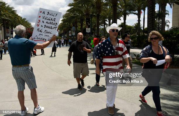 People walk towards the Anaheim Convention Center as U.S. Republican Presidential candidate Donald Trump was to speak inside, May 25, 2016 in...