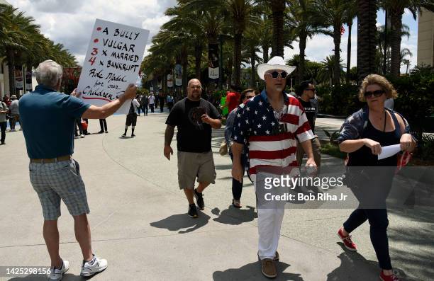 People walk towards the Anaheim Convention Center as U.S. Republican Presidential candidate Donald Trump was to speak inside, May 25, 2016 in...